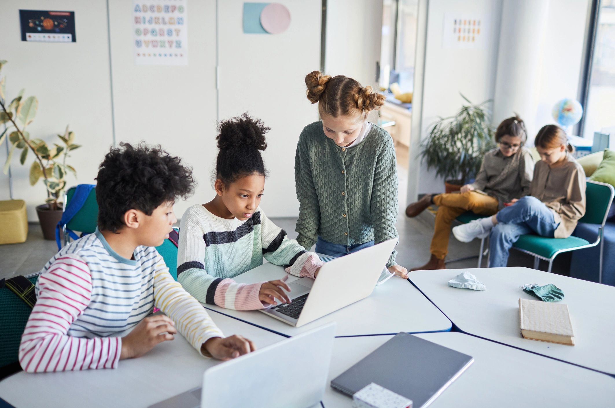 Students working together at a desk in a modern school